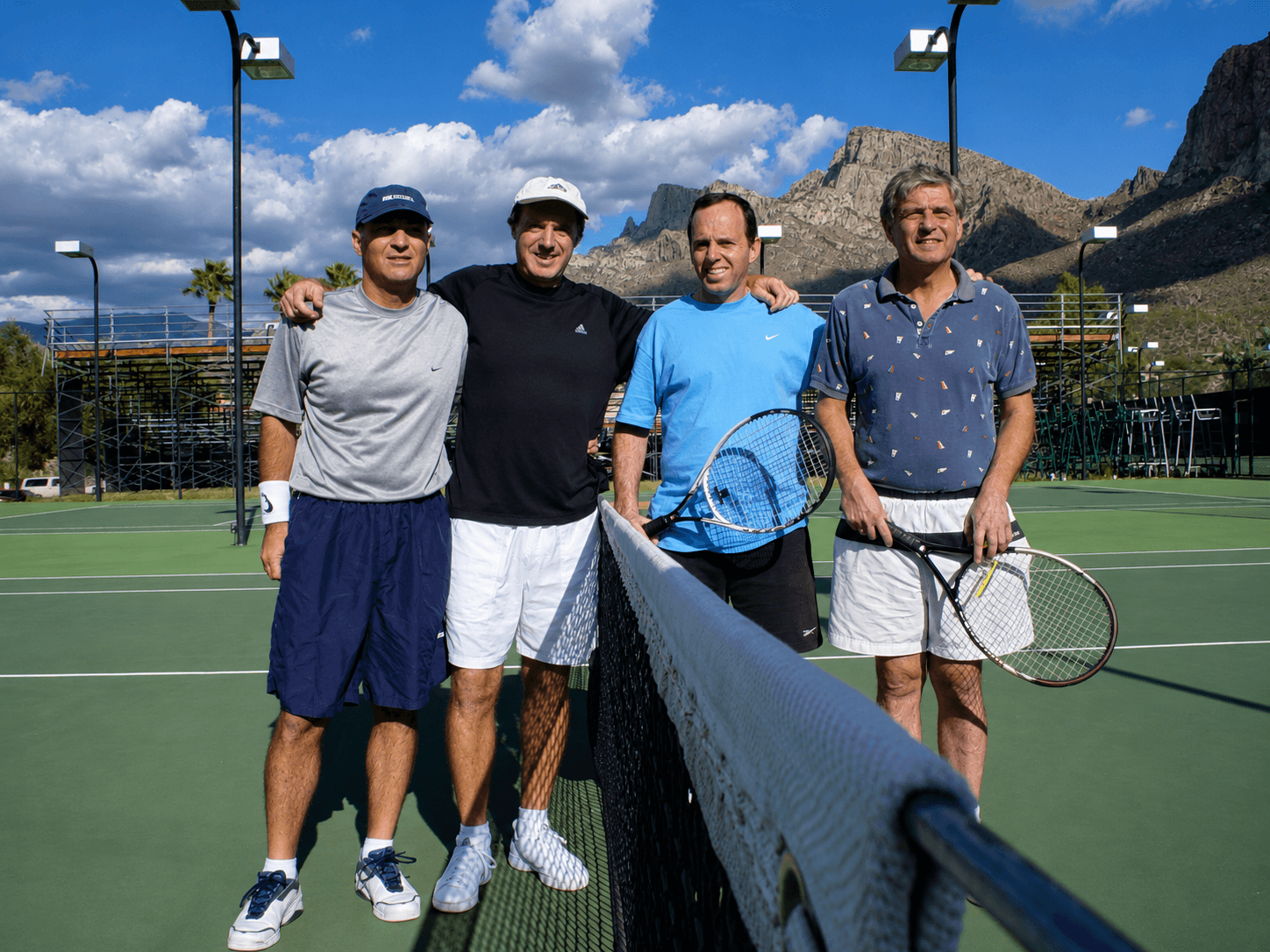 Adult tennis group with Arizona mountains