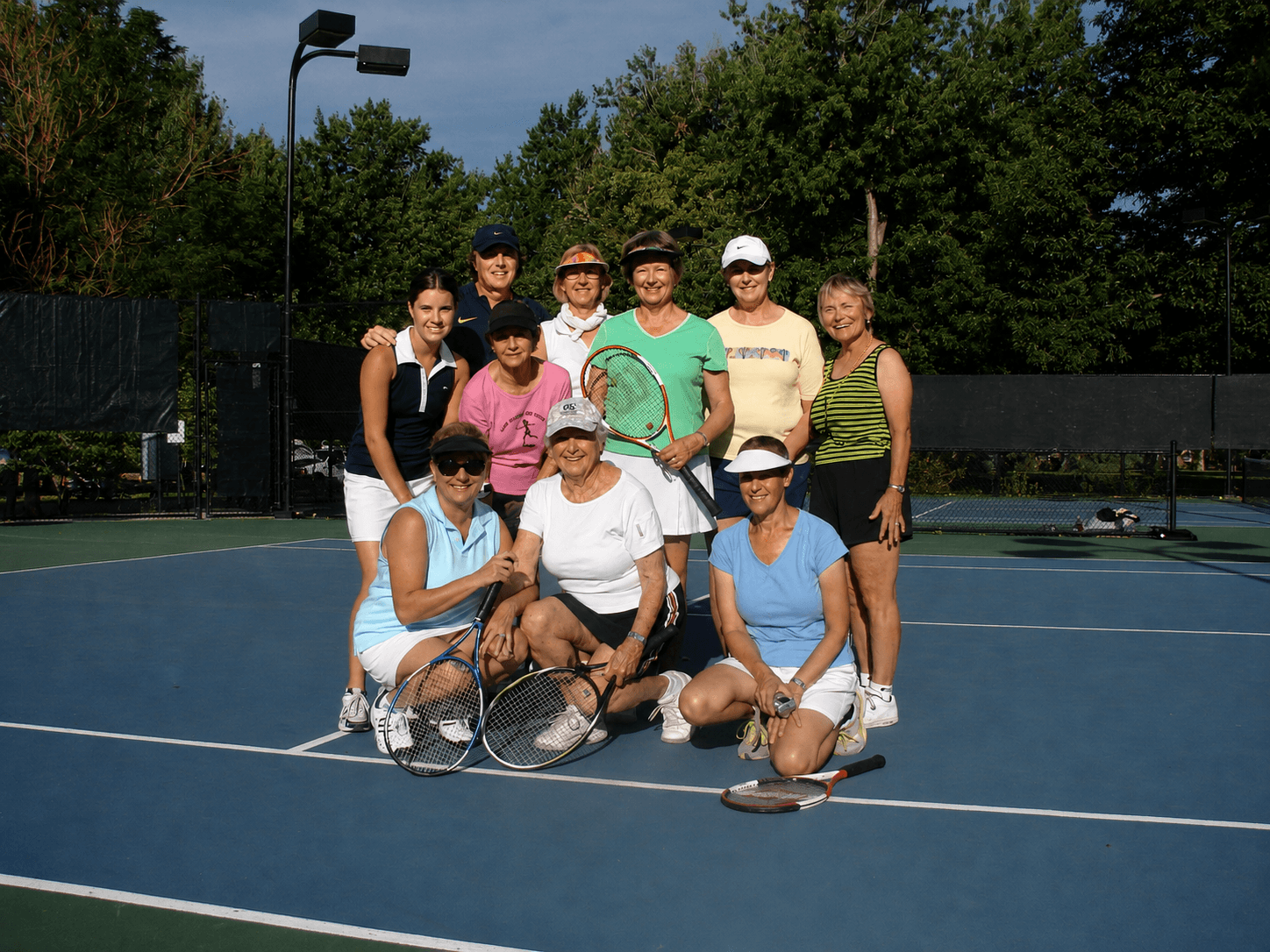 Jorge Pensky with a group of adult tennis players