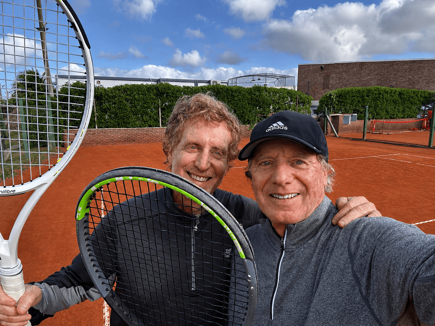 Jorge Pensky with an older tennis client and a younger player