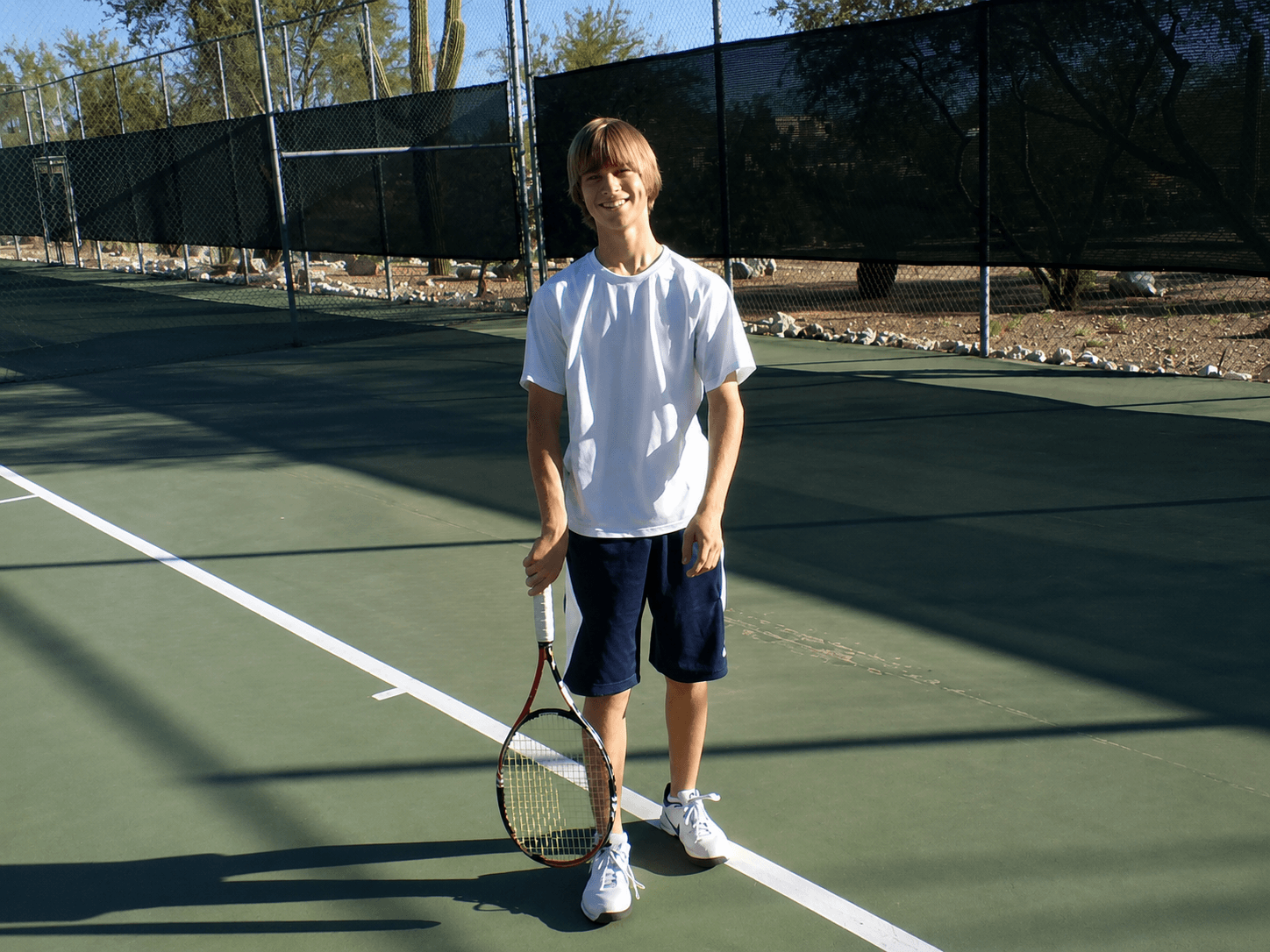 High school tennis player on court