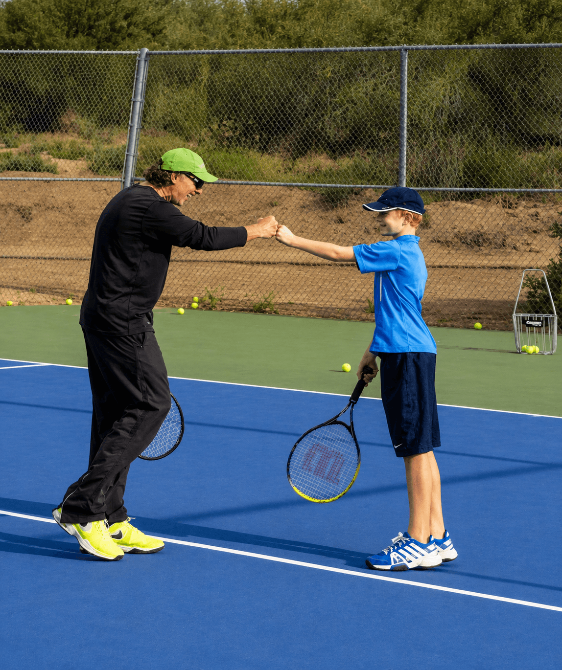 Jorge coaching a young tennis student