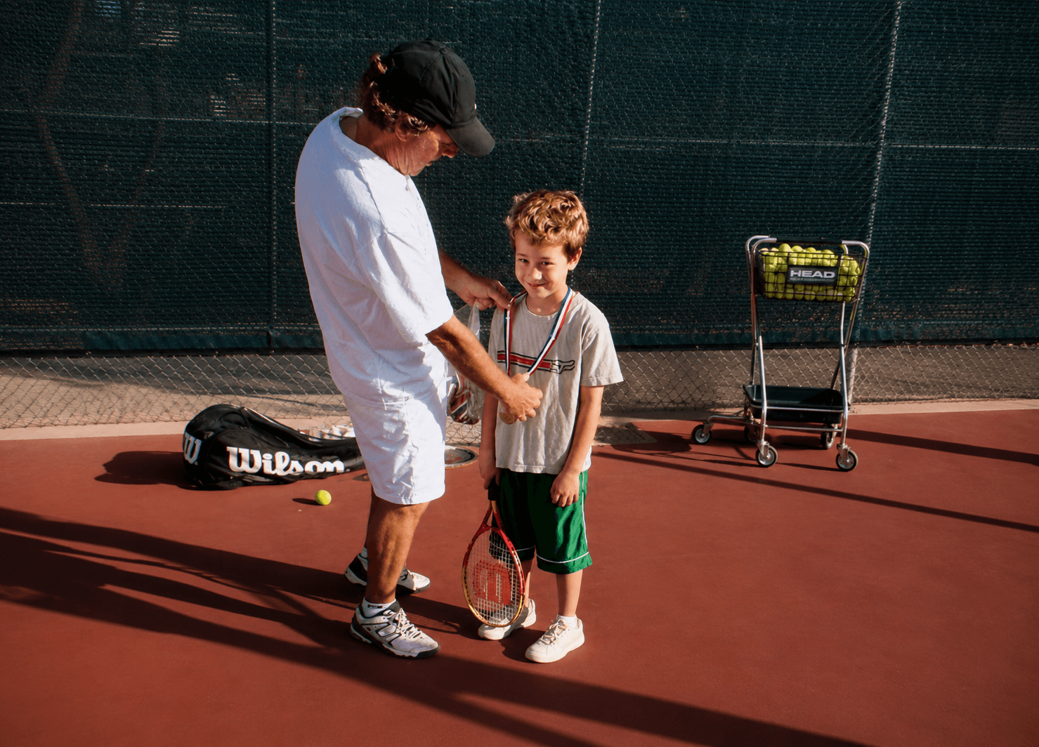Jorge giving instruction to a young tennis player